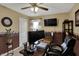Inviting home office with a dark wood desk, comfortable leather chair, and a large monitor at 7233 Capel Dr, Indianapolis, IN 46259