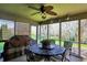 Cozy screened patio offers a shaded retreat with a ceiling fan and space for outdoor dining and relaxation at 7233 Capel Dr, Indianapolis, IN 46259