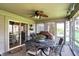 Relaxing screened patio complete with outdoor furniture, ceiling fan, and serene views of the backyard at 7233 Capel Dr, Indianapolis, IN 46259