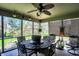 Charming screened patio with a ceiling fan and ample space for outdoor dining and enjoying the peaceful surroundings at 7233 Capel Dr, Indianapolis, IN 46259