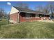 Spacious backyard featuring a well-maintained lawn and a classic brick facade at 731 W Stop 11 Rd, Indianapolis, IN 46217