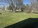 Expansive front yard offers a tranquil view of mature trees and lush greenery at 731 W Stop 11 Rd, Indianapolis, IN 46217