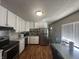 Bright kitchen with white cabinets, stainless steel appliances, and a dining area at 731 W Stop 11 Rd, Indianapolis, IN 46217