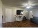 Living room with wood floors, ceiling fan, and mounted tv for relaxing at 731 W Stop 11 Rd, Indianapolis, IN 46217