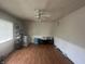 Spacious living room with wood floors, a ceiling fan, and ample space for furniture at 731 W Stop 11 Rd, Indianapolis, IN 46217