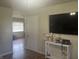 Cozy living room with modern decor, featuring wood floors and a sleek, wall-mounted television at 731 W Stop 11 Rd, Indianapolis, IN 46217