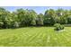 Spacious backyard with mature trees, offering a serene and private outdoor retreat at 7341 Campfire Run, Indianapolis, IN 46236