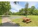 Community basketball court and picnic table surrounded by trees at 7341 Campfire Run, Indianapolis, IN 46236