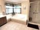 Bright bathroom with separate soaking tub and shower for a spa-like experience at 7341 Campfire Run, Indianapolis, IN 46236
