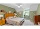 Cozy bedroom with hardwood headboard, window seat and natural light at 7341 Campfire Run, Indianapolis, IN 46236