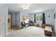 Spacious bedroom with a ceiling fan, plush carpeting, and relaxing seating area by the bright window at 7341 Campfire Run, Indianapolis, IN 46236