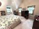 Comfortable bedroom with natural light, vaulted ceilings and plush carpet flooring at 7341 Campfire Run, Indianapolis, IN 46236