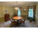 Traditional dining room with wood table, chairs, chandelier, and natural light at 7341 Campfire Run, Indianapolis, IN 46236