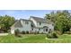 Well-maintained home exterior with a lush backyard, featuring a garden and manicured lawn at 7341 Campfire Run, Indianapolis, IN 46236