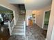 Spacious foyer featuring tiled flooring, stairs to the upper level, and coat closet at 7341 Campfire Run, Indianapolis, IN 46236