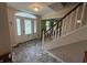 Welcoming foyer with tile flooring, decorative glass front door, and staircase at 7341 Campfire Run, Indianapolis, IN 46236