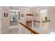 Upstairs hallway with neutral carpet and railings, offering a view of the open floor plan at 7341 Campfire Run, Indianapolis, IN 46236