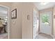Bright hallway with tiled flooring, neutral walls, and a view into another room at 7341 Campfire Run, Indianapolis, IN 46236