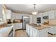 Stylish kitchen with white cabinets, granite countertops, and stainless steel appliances at 7341 Campfire Run, Indianapolis, IN 46236
