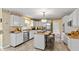 Bright kitchen featuring white cabinetry, granite countertops, and stainless steel appliances at 7341 Campfire Run, Indianapolis, IN 46236
