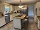 Updated kitchen with stainless appliances, a center island, and tile floors at 7341 Campfire Run, Indianapolis, IN 46236