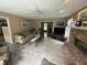 Comfortable living room with brick fireplace, ceiling fan, and access to other rooms at 7341 Campfire Run, Indianapolis, IN 46236