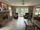 Relaxing living room featuring a brick fireplace and sliding glass doors at 7341 Campfire Run, Indianapolis, IN 46236