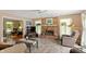 Bright living room with a brick fireplace, recessed lighting, and access to the backyard at 7341 Campfire Run, Indianapolis, IN 46236
