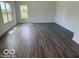 Open-concept living room featuring hardwood floors, recessed lighting, and natural light at 7549 Big Bend Blvd, Camby, IN 46113