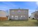 Spacious backyard with a sliding glass door entrance, providing an open space for outdoor activities at 8926 Poppy Ln, Indianapolis, IN 46231