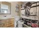 Cozy bathroom with a framed mirror, wooden vanity, and a shower featuring unique artistic decorations at 8926 Poppy Ln, Indianapolis, IN 46231