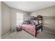 Cozy bedroom with a bunk bed, soft carpet, and a window providing natural light at 8926 Poppy Ln, Indianapolis, IN 46231
