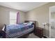 Comfortable bedroom with a bed, window, and a nightstand, creating a peaceful and inviting space at 8926 Poppy Ln, Indianapolis, IN 46231