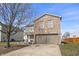 Attractive two-story residence featuring a brick and siding exterior, a well-kept lawn, and a paved driveway at 8926 Poppy Ln, Indianapolis, IN 46231