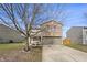Inviting two-story house with a brick and siding facade, a driveway, and a simple landscaped yard at 8926 Poppy Ln, Indianapolis, IN 46231