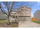 Charming two-story home with a brick facade and a two-car garage, complemented by mature trees at 8926 Poppy Ln, Indianapolis, IN 46231