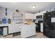 Well-lit kitchen equipped with stainless steel appliances, ample white cabinetry, and a functional center island at 8926 Poppy Ln, Indianapolis, IN 46231