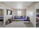 A comfortable living room showcasing a plush, purple sectional sofa and ambient lighting for relaxed living at 8926 Poppy Ln, Indianapolis, IN 46231