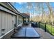 Extensive back deck with dining set, barbecue, and hot tub provides an ideal setting for entertaining amidst natural surroundings at 9334 Seascape Dr, Indianapolis, IN 46256