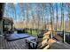 Expansive back deck with hot tub, barbecue, and dining area offers a luxurious outdoor experience with beautiful natural backdrop at 9334 Seascape Dr, Indianapolis, IN 46256