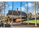 Beautifully landscaped backyard with mature trees, a multi-level deck, and a brick chimney at 9334 Seascape Dr, Indianapolis, IN 46256