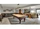 Finished basement area with a pool table, comfortable seating, and easy access to the outdoors at 9334 Seascape Dr, Indianapolis, IN 46256