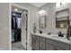 Bathroom featuring a double vanity, modern fixtures, and a walk in closet full of clothes at 9334 Seascape Dr, Indianapolis, IN 46256
