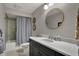 Bathroom featuring a single vanity with modern fixtures, and a shower/tub combo with blue tile at 9334 Seascape Dr, Indianapolis, IN 46256
