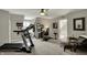 Bonus room featuring a treadmill, home office, and ceiling fan at 9334 Seascape Dr, Indianapolis, IN 46256