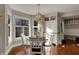 Sunlit breakfast nook features a round table and built-in storage near large windows at 9334 Seascape Dr, Indianapolis, IN 46256