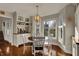 Bright breakfast nook with a round table, modern light fixture, and built-in coffee bar at 9334 Seascape Dr, Indianapolis, IN 46256