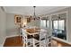 Bright dining room with wood floors, modern lighting fixture, and view to a screened in porch at 9334 Seascape Dr, Indianapolis, IN 46256