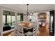 Open-concept dining room with wood floors and adjacent to the living room with fireplace feature at 9334 Seascape Dr, Indianapolis, IN 46256