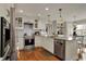 Modern kitchen with stainless steel appliances, white cabinets, and hardwood floors with eating area at 9334 Seascape Dr, Indianapolis, IN 46256
